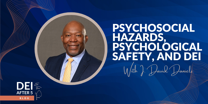 photo of I. David Daniels in a navy suit, blue shirt, and yellow tie smiling at the camera